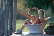 Woman Bathing Outdoors in Old Tub